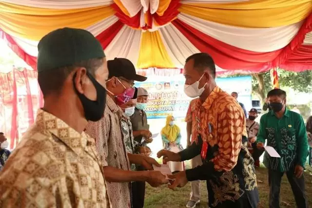 RINGANKAN: Bupati Tala HM Sukamta menyerahkab bantuan kepada warga pada kegiatan manunggal tuntung pandang.