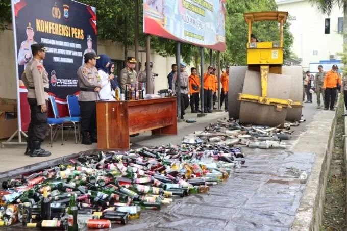 DILINDAS STUM: Botol miras dan knalpot brong yang disita Polres Banjarbaru dimusnahkan dengan dilindas alat berat. | FOTO: M FADLAN ZAKIRI/RADAR BANJARMASIN
