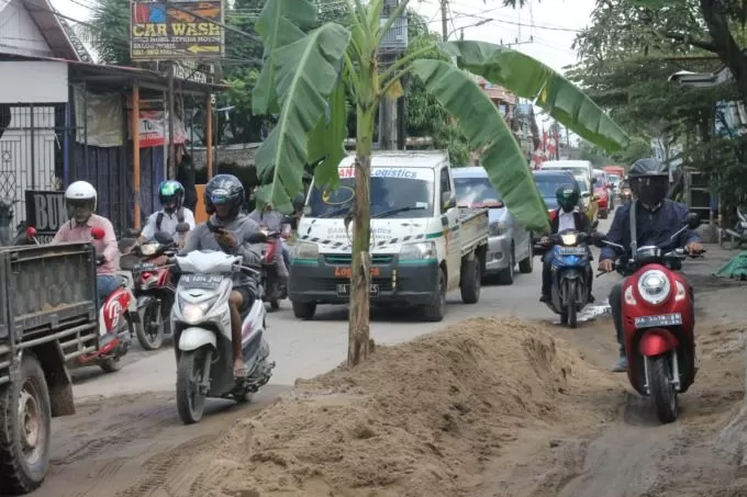 TANAM PISANG: Cara warga memprotes terkait kerusakan jalan. Kini protes seperti itu bisa dilaporkan melalui SP4N Lapor! Kota Banjarmasin. | FOTO: WAHYU RAMADHAN/RADAR BANJARMASIN