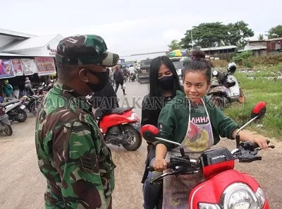DIABAIKAN: Petugas menegur salah seorang pengendara yang masuk ke Pasar Induk, Tanjung Selor karena tidak menggunakan masker./PIJAI PASARIJA/RADAR KALTARA