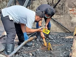 OLAH TKP : Personel Unit Inafis Satreskrim Polres Tarakan mengecek arang di lokasi gudang yang terbakar. ELIAZAR/RADAR TARAKAN