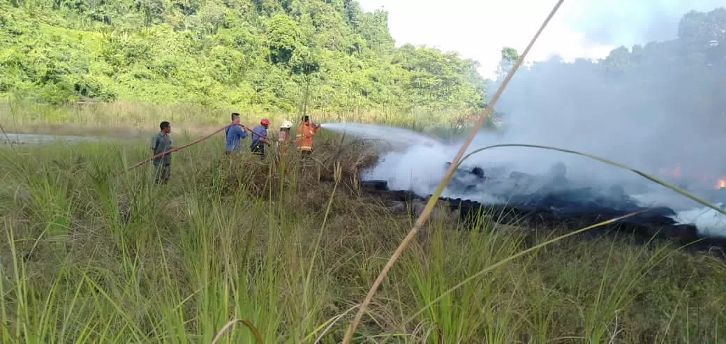 GERAK CEPAT: Petugas Damkar Malinau berusaha melakukan pemadaman api yang membakar lahan dan tumpukan ban bekas. (IST)