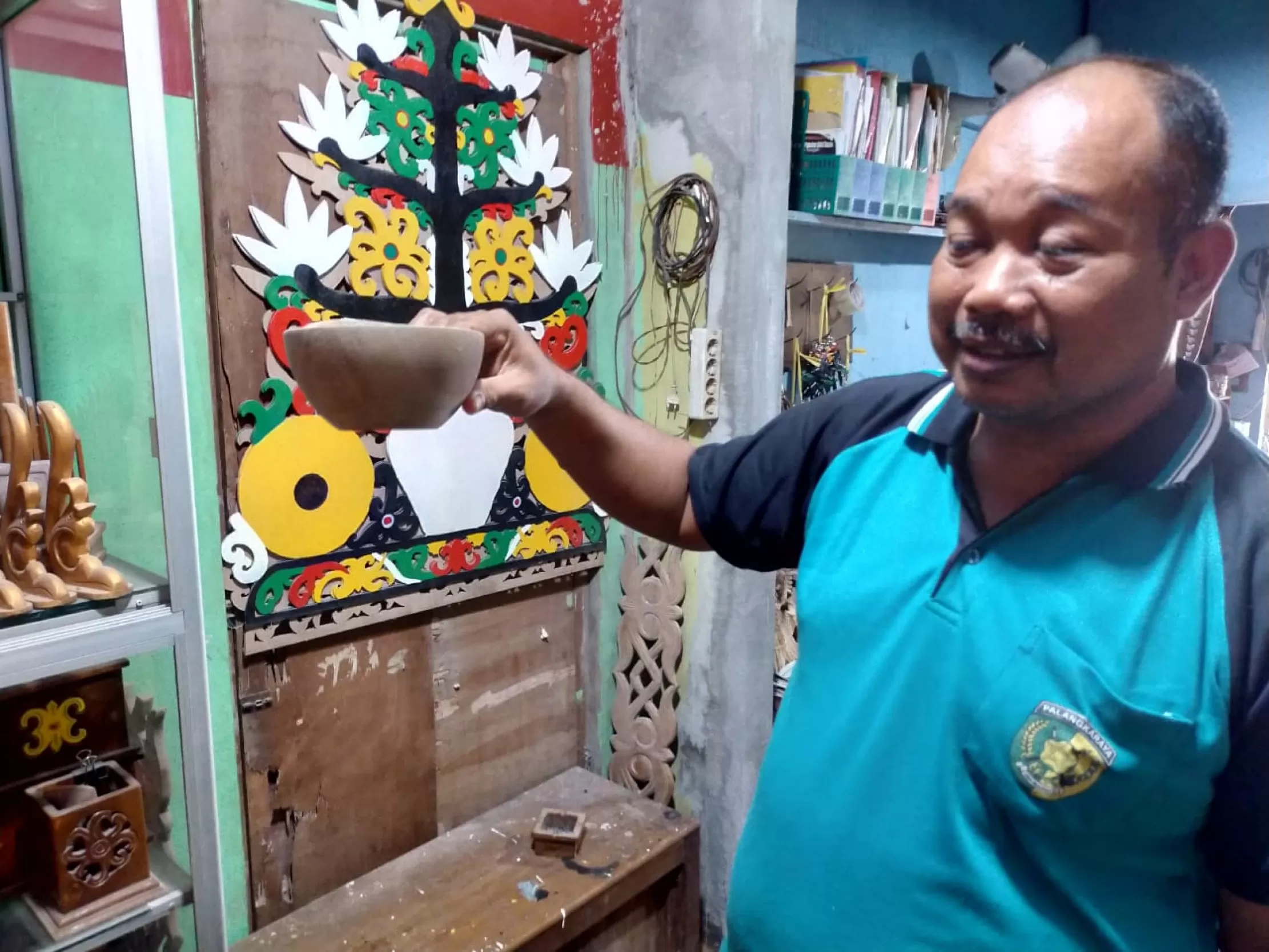 HASIL KARYA: Berbagai macam ornamen khas Dayak diproduksi oleh Workshop Patra Craft di Kelurahan Sebaru. INSET: Abdullah Gampang menunjukkan hasil kerajinannya.