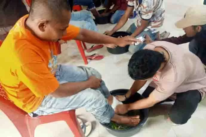 Seorang pelanggar penjual miras saat diberikan sanksi mencuci kaki orang tuanya.
