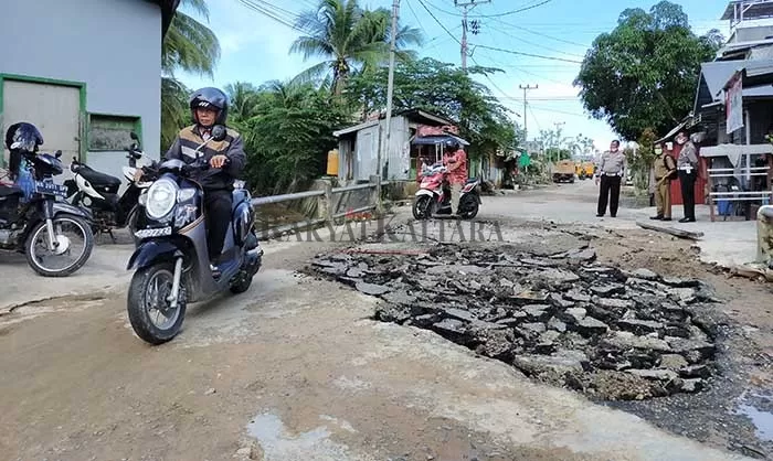 PENANGANAN SEMENTARA: Kondisi Jalan Kenanga RT 17 yang rusak, diratakan dengan menggunakan aspal bekas.