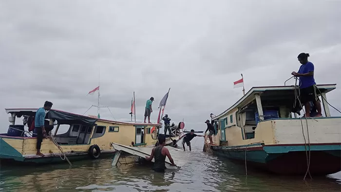 DAMPAK CUACA EKSTREM: Kapal nelayan yang tenggelam di Perairan Pulau Bunyu berusaha dievakuasi.