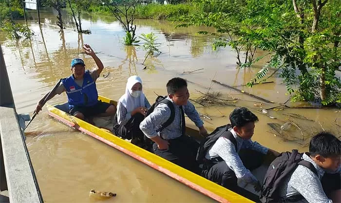 TETAP SEMANGAT: Pelajar SMAN I Sembakung yang rela mengarungi banjir demi bisa ikut pelaksanaan OSN.