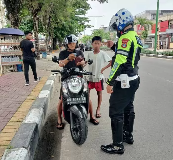 LANGGAR LALIN: Personel Satlantas Polres Tarakan berupaya menindak pengendara sepeda motor karena melawan arah.