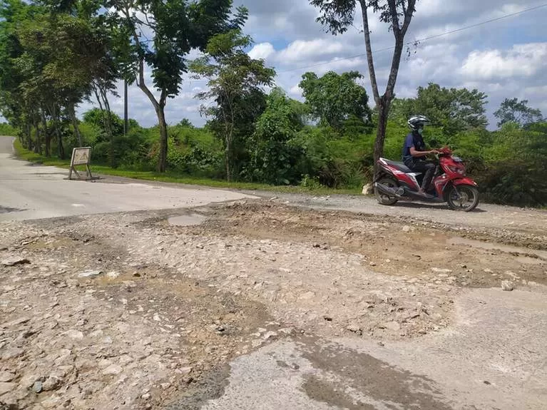 AKSES HANCUR: Jalan Soekarno-Hatta mengalami kerusakan berat, akibat rutin dilintasi oleh kendaraan bermuatan berat milik perusahaan swasta.
