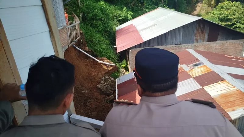 Petugas BPBD Kota Padang melakukan assessment di lokasi tanah terban yang menghancurkan dapur rumah milik warga di Jalan Bukit Peti Peti, Kelurahan Teluk Bayur, Kecamatan Padang Selatan, Senin (15/6/2026) siang.