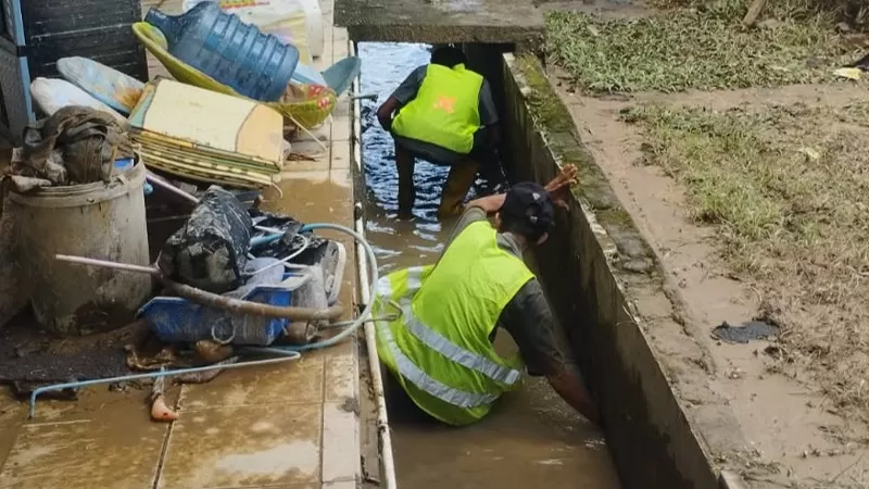 Tim Reaksi Cepat Dinas PUPR Kota Padang melakukan penggalian sedimen dan pembersihan material lumpur di sejumlah lokasi terdampak hujan berintensitas tinggi yang terjadi sejak Senin (3/8/2026) siang. (Dok. PUPR)