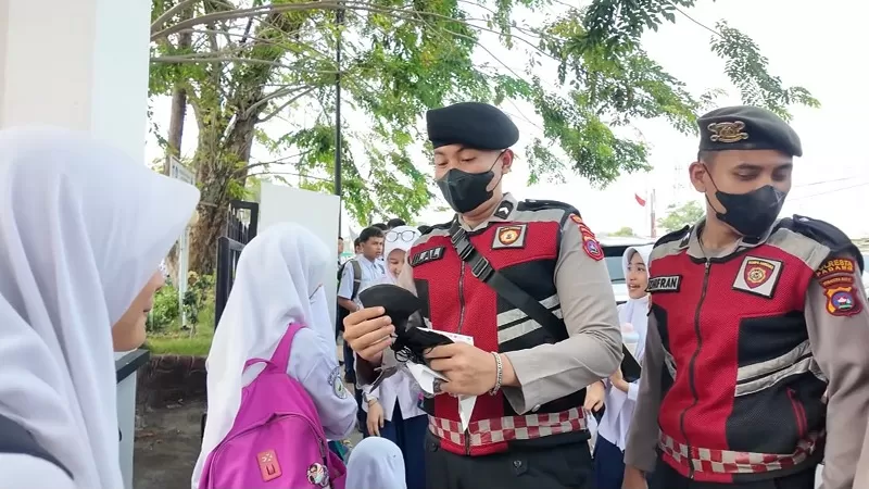 Personel Polresta Padang membagikan masker kepada anak sekolah dan masyarakat sebagai langkah pencegahan dampak kabut asap, Senin (7/9/2026) siang. (Dok. Humas)