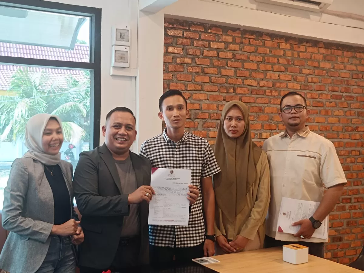 Ketua TAM, Ahmad Yusuf, didampingi Marjani (kemeja kotak-kotak) dan istri, memperlihatkan surat gugatan PMH terhadap KPK ke PN Pekanbaru, saat jumpa pers, Jumat, 10 April 2026.