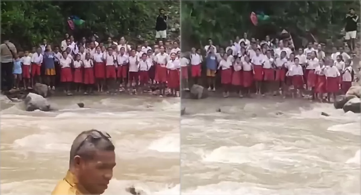 Siswa SDN Oelbaf NTT menyambut Kepala Dinas dari seberang sungai dengan yel-yel Ayo Maju Jangan Ragu, di tengah akses sekolah yang menantang. (Instagram.com/fakta.indo)