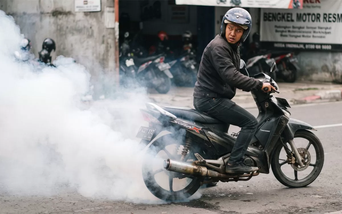 Asap putih dari knalpot menjadi salah satu tanda motor ngebul yang dapat berkaitan dengan oli masuk ke ruang bakar. (Dok. Promedia)