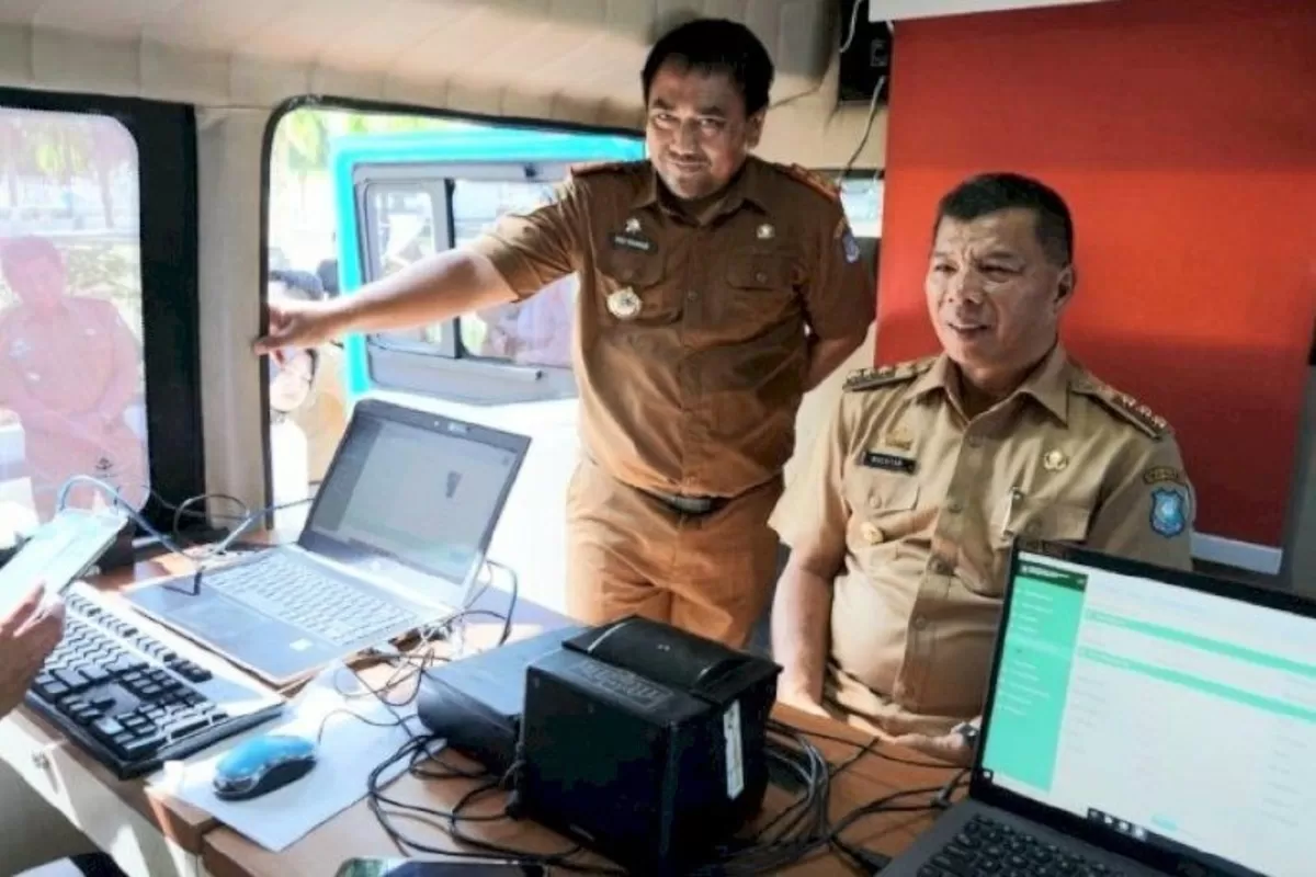 Kepala Dinas Kependudukan dan Pencatatan Sipil Bulukumba, Dedi Rahmadi saat mendampingi Bupati Bulukumba ujicoba e-KTP mobile.