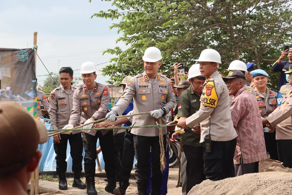 Kapolres Subang AKBP Dony Eko Wicaksono beserta jajaran menarik tali untuk merobohkan bangunan dalam kegiatan bedah rumah tidak layak huni di wilayah Kabupaten Subang, Jumat 27 Februari 2026 (Dok. Istimewa)