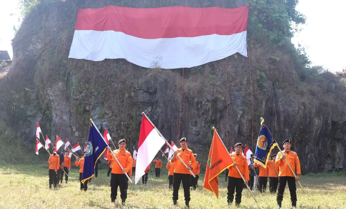 Personel SAR Semarang membentangkan Bendera Merah Putih berukuran 25 x 10 meter dengan teknik rappelling di Tebing Djaro, Desa Pagertoyo, Kecamatan Limbangan, Kabupaten Kendal. (KabarSatu.id / Foto: SAR)