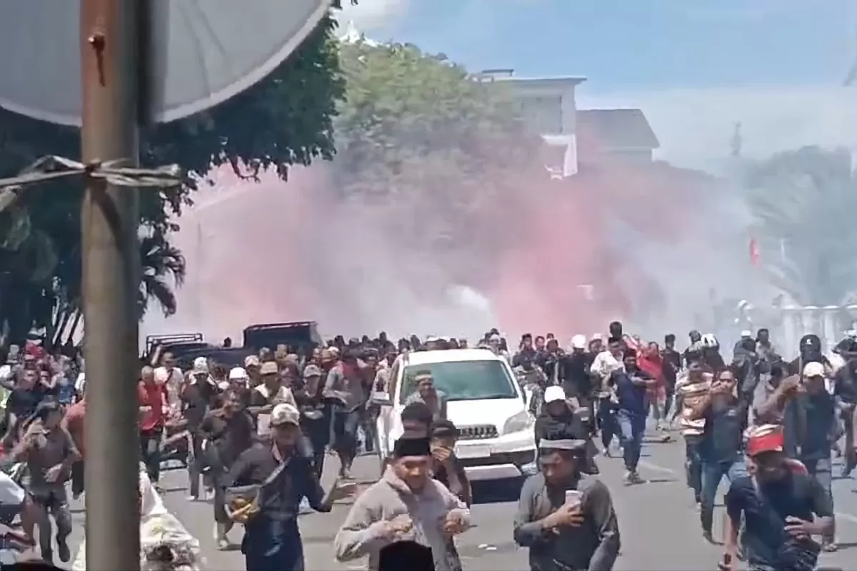 Kepanikan massa saat aparat keamanan melepaskan tembakan gas air mata untuk membubarkan kericuhan yang pecah pada peringatan Hari Damai Aceh ke-21 di Banda Aceh, Sabtu (15/8/2026). (Foto: KOMPAS.com/Zuhri Noviandi)