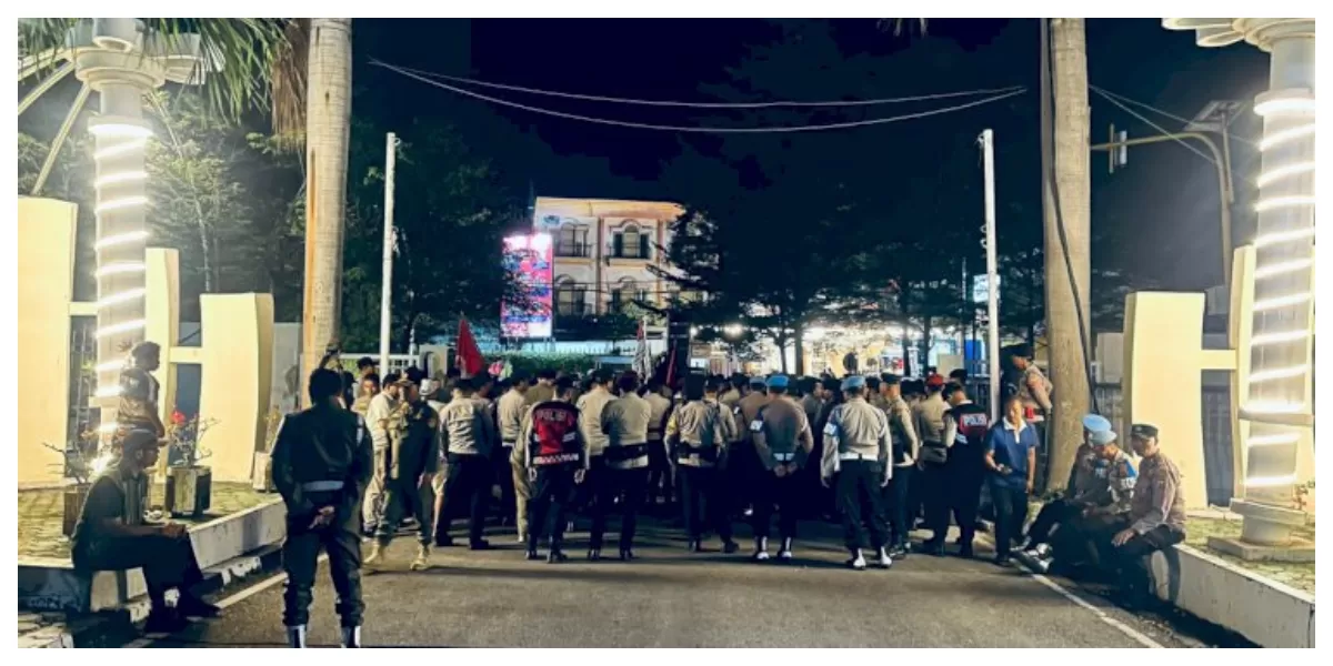 Personel Polresta Kupang Kota mengawal jalannya aksi Aliansi Anti Imperialis NTT di depan Kantor Gubernur NTT, Sabtu malam, berlangsung aman kondusif.  (Foto TBN Polresta Kupang Kota)