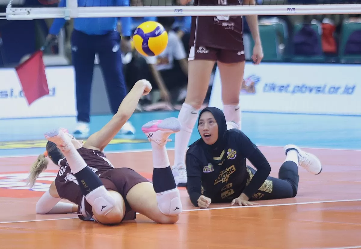 Dua pemain, Electric PLN berusaha mengambil bola pengembalian lawan hingga tersungkur di lantai, pada final four seri terakhir di Semarang, Kamis, 16 April 2026. PLN kandas 1-3 dari Gresik Phonska.  (PBVSI)