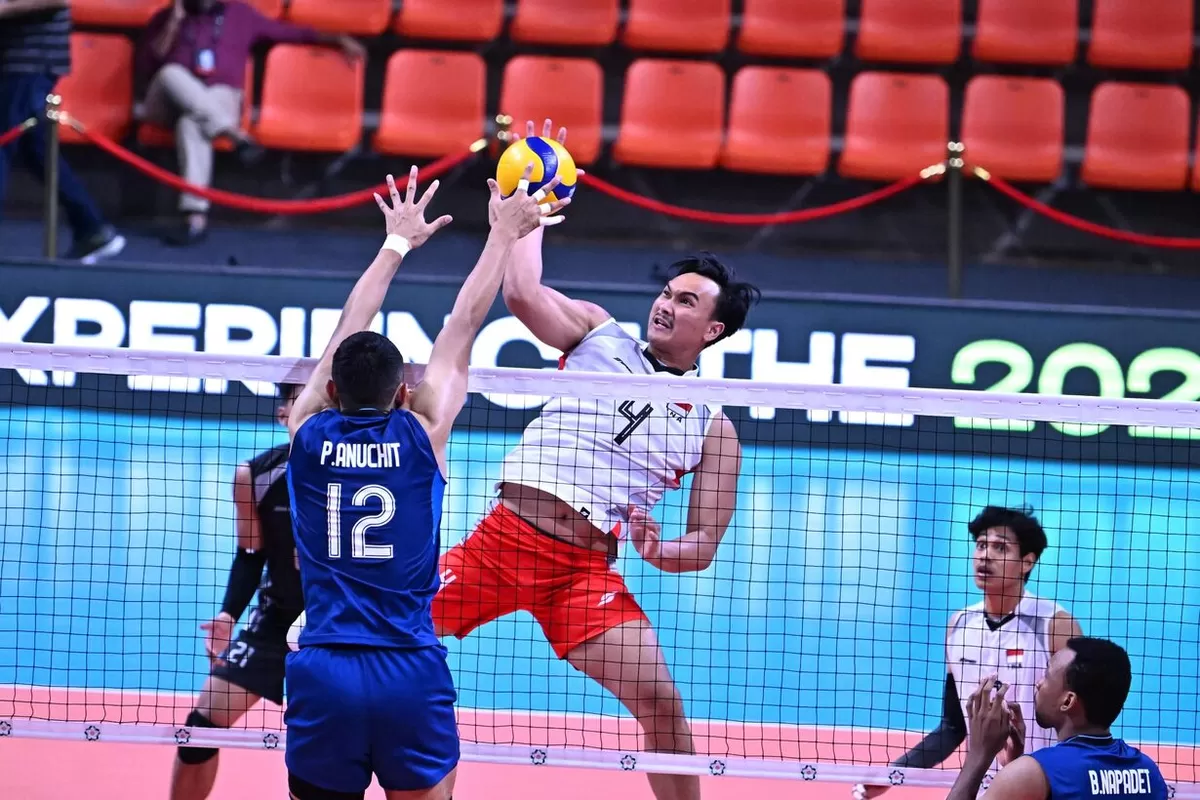 Middle blocker Timnas Voli Putra Indonesia, Hendra Kurniawan melayangkan smes keras yang coba dihalau oleh pemain Thailand dalam laga ketiga AVC Cup Men 2026 di India, Selasa, 23 Juni 2026.