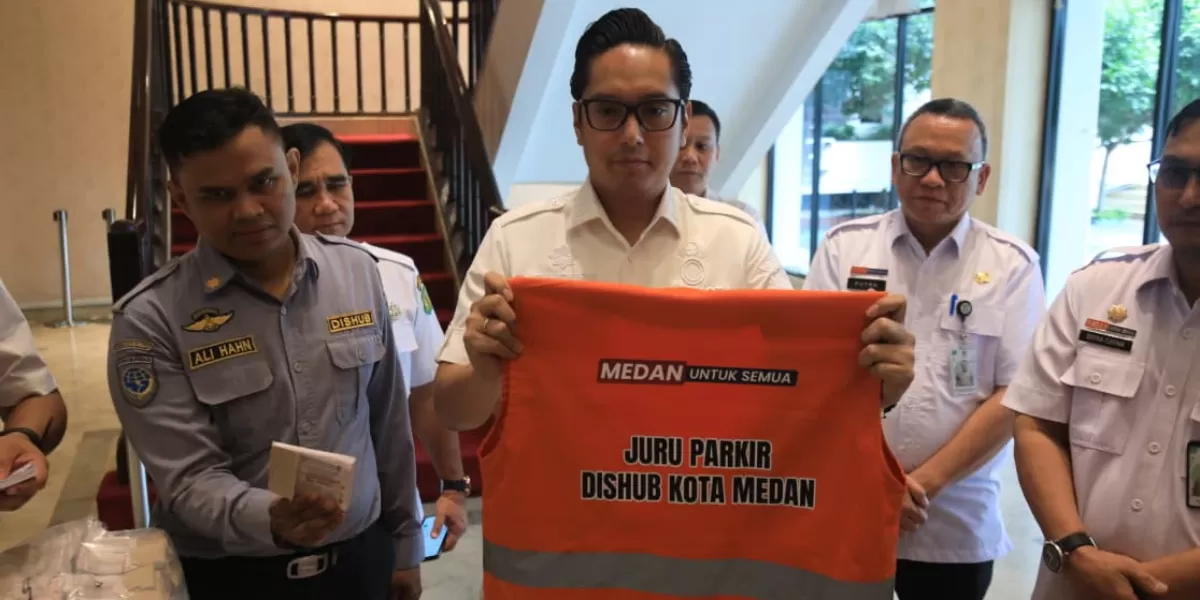 Pemko Medan turunkan tarif parkir, Wali Kota Rico Waas kena rompi kepada salah seorang Jukir yang akan mengikuti pelatihan yang diselenggarakan Dishub, Rabu (25/2/2026).