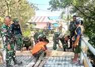 Anggota Koramil 1312-03/Beo Bersama Warga Melaksanakan Karya Bhakti Pembuatan Jembatan