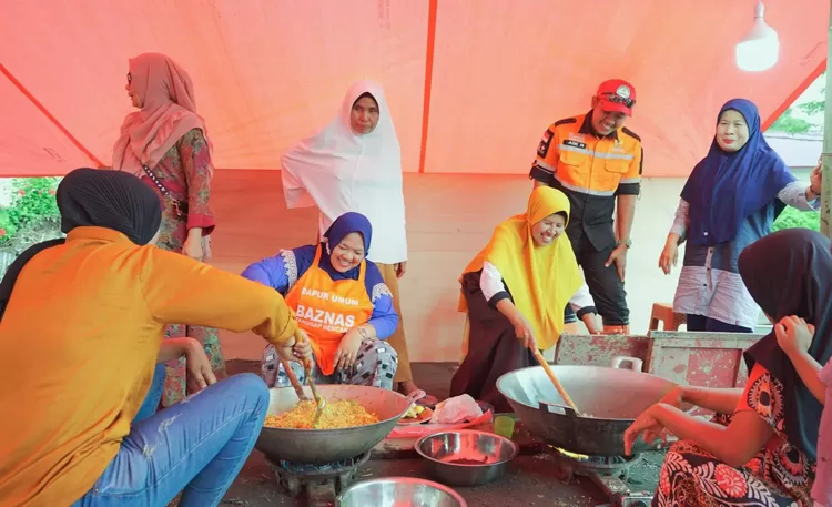 Belasan relawan ibu-ibu  memasak  adi dapur umum Baznas, menyediakan makan bagi  ribuan  pengungsi korban banjir di Sumbar.