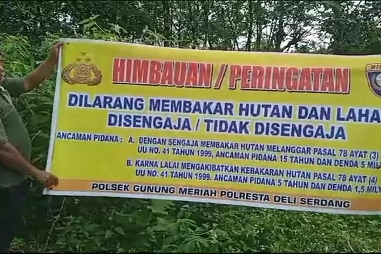 Petugas Polsek Gunung Meriah dan Warga memperlihatkan Spanduk tanda himbauan/larangan membakar hutan (Realitasonline.id/zul)