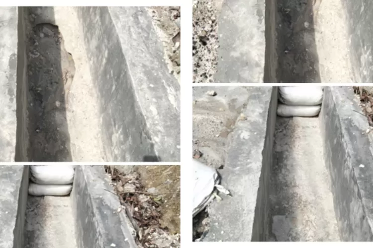 Inilah kondisi saluran parit yang merupakan paket jalan hotmix di Hutatinggi -Simamora Parmonangan tampak lantainya berlubang. (Realitasonline.id/ AS)