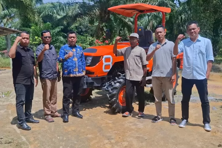 Ketua DPD Tani Merdeka Indonesia Kabupaten Labuhanbatu, Asrol Azis Lubis beserta unsur pengurus, saat menyerahkan 1 unit Traktor kepada kelompok tani di Kecamatan Bilah Barat