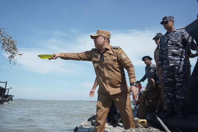 Wabup saat melakukan tabur bibit kerang darah (Realitasonline.id - Ist)