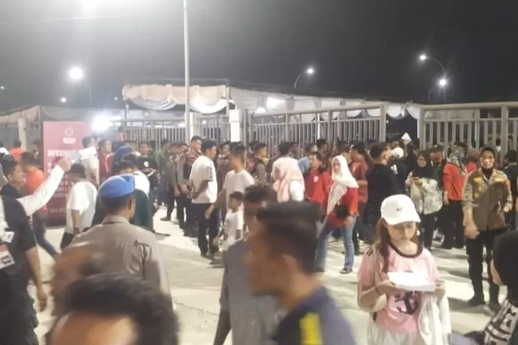 Para penggemar sepak bola yang akan menonton  tertib menunggu didepan pintu masuk yang dijaga oleh personil gabungan