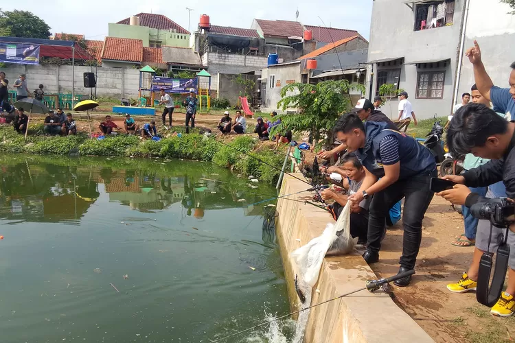 Caleg DPRD Kota Bekasi dari Partai NasDem, Bagas Angga Wildan saat melempar ikan Bawal dalam kebersamaan mancing bersama warga di Empang Situ Rawalumbu, Kota Bekasi, Minggu (3)12)2023). (FOTO: Dharma/Suarakarya.id)