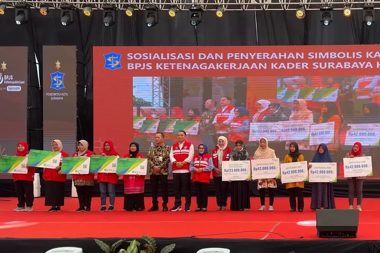 Wali Kota Surabaya Eri Cahyadi dan Kepala Kantor Wilayah BPJS Ketenagakerjaan Jawa Timur, Hadi Purnomo (tengah) diantara para penerima santunan dan kartu peserta