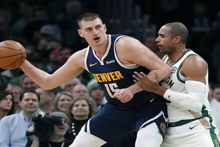 Denver Nuggets' Nikola Jokic (15) is defended by Boston Celtics' Al Horford during the first half of an NBA basketball game Friday, Jan 19, 2024, in Boston. ( (AP Photo/Michael Dwyer))