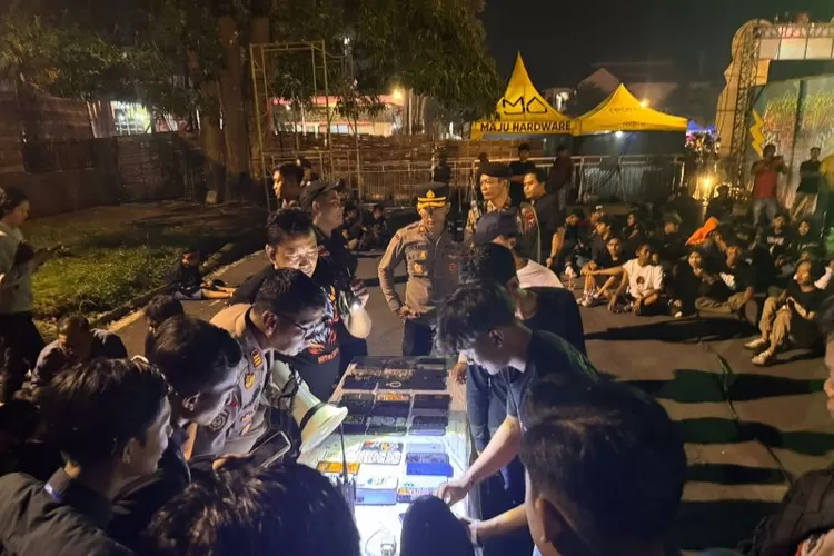 Anggota Sabhara Polres Tulungagung memeriksa ponsel penonton satu per satu untuk menemukan ponsel yang dilaporkan hilang dicopet di GOR Lembupeteng, Tulungagung, Sabtu (8/2/2025).  (ANTARA/HO - Joko Pramono)