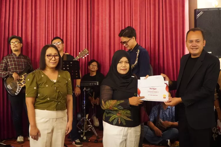 Direktur Utama Taru Martani, Widayat Joko Priyanto (kanan) memberikan penghargaan kepada salah satu pelinting cerutu Taru Martani yang telah berdedikasi lebih dari 25 tahun.  (Foto: Dok. Istimewa)