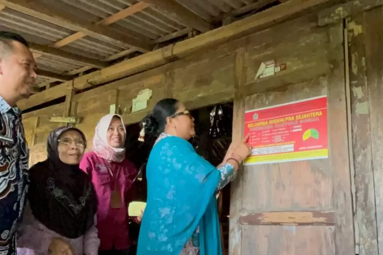 Bupati Gunungkidul Endah Subekti Kuntariningsih memasang stiker keluarga miskin prasejahtera sebagai tanda agar bantuan tepat sasaran. Kamis (11/12/2025).  (ANTARA/Ho-Kominfo Gunungkidul)