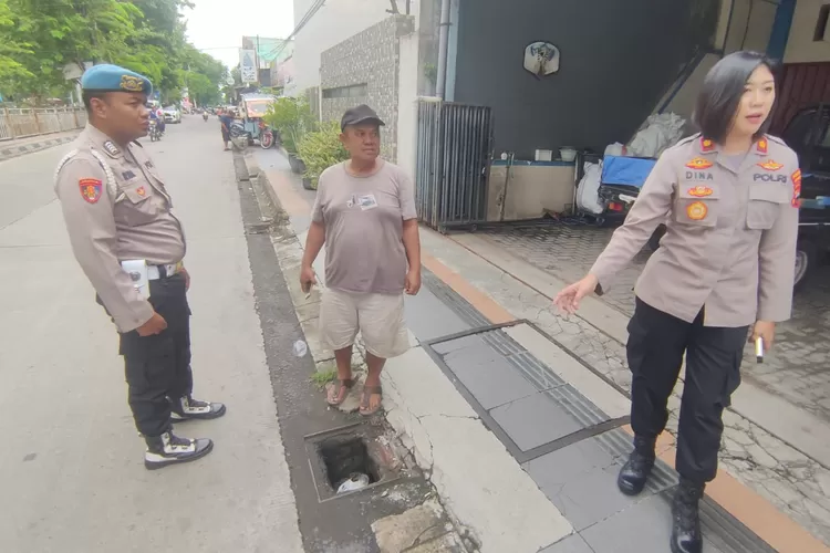 Kapolsek Pedurungan Kompol Dina Novitasari saat mengecek penutup selokan warga Tlogosari Semarang yang hilang.  ((Ayosemarang.com/ Audrian Firhannusa))