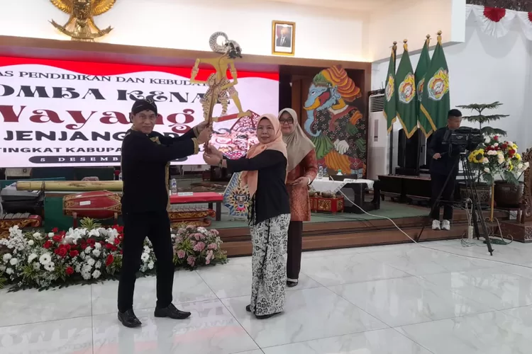 Kepala Bidang Kebudayaan Disdikbud Kendal menyerahkan wayang saat lomba kenal wayang jejang SD di Pendopo Bahuresko Kamis 5 Desember 2024.  (edi prayitno/kontributor kendal)