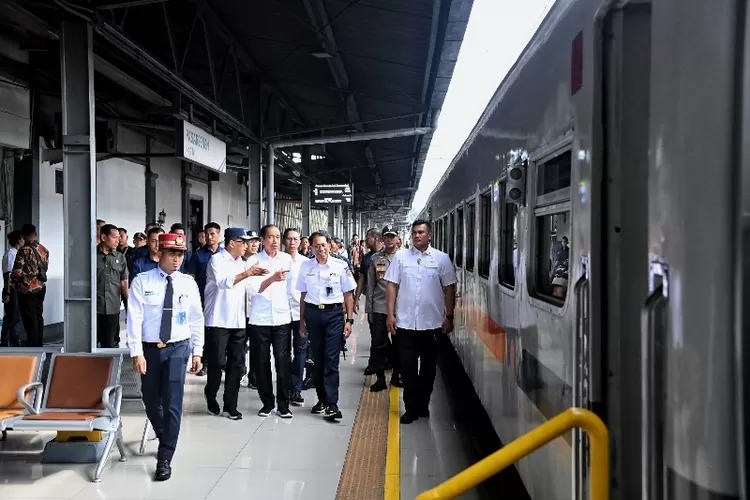 President Joko Widodo watches arrivals at the train station on Monday