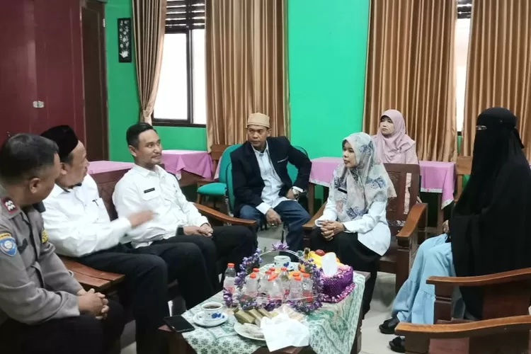 Bhabinkamtibmas Lewinanggung Sugitarto, dan Lurah Leuwinanggung Titin Sumarsih saat menghadiri rapat di SMPN 24 Depok, Jalan Keramat Leuwinanggung, Kecamatan Tapos, Kota Depok, beberapa waktu lalu.  (AGNESYA WIANDA/RADAR DEPOK)