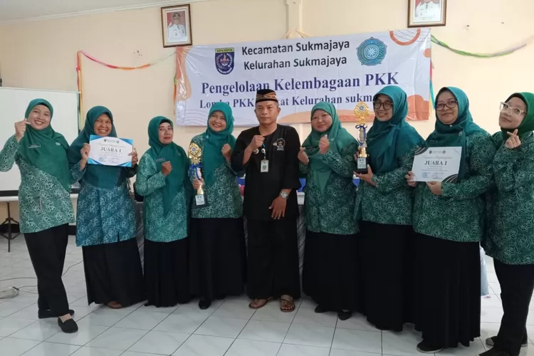 Lurah Sukmajaya, Mulyadi bersama Ketua TP PKK, Siti Sarofah foto bersama pemenang lomba PKK tingkat kelurahan di Aula Kelurahan Sukmajaya, Kecamatan Sukmajaya, Kamis (30/5). (AGNESYA WIANDA/RADAR DEPOK)