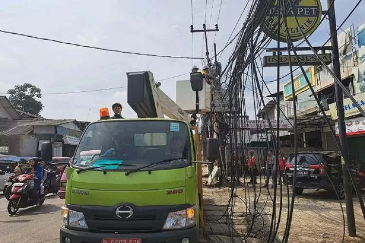 Suasana DPUPR Kota Depok saat merapihkan kabel yang semrawut di Jalan Tole Iskandar, Kecamatan Sukmajaya, Kota Depok, beberapa waktu lalu.  (ISTIMEWA)
