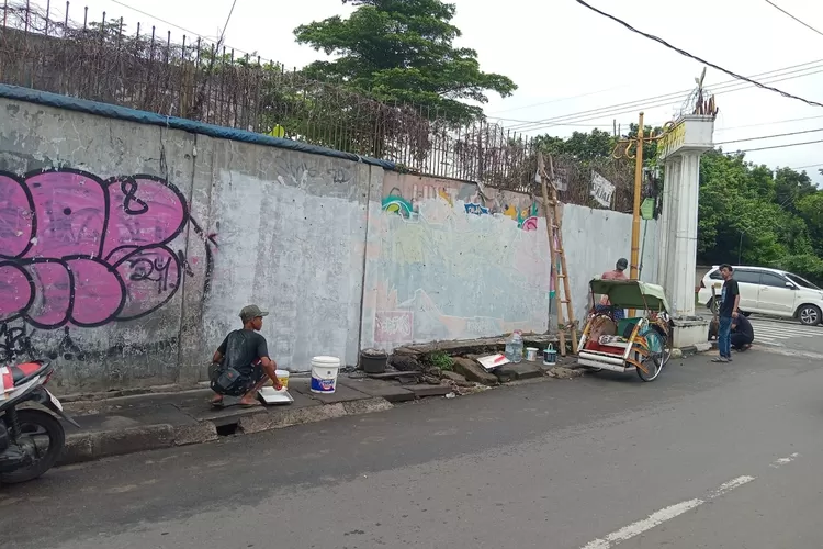 Sentral Komunikasi Orang Depok (SKOP) bersama Aliansi Lingkungan Pararaja Kota Depok mengecat tembok eks pabrik aki, di Jalan Pemuda, RT1/8, Kelurahan Depok, Kecamatan Pancoranmas, Rabu (26/7).  (RISKY DWI LESTARI/RADAR DEPOK)