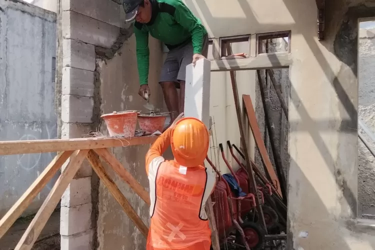 Sekretaris Kelurahan Cinangka, Hendrik Sugianto dan Kasi Ekbang Kelurahan Cinangka Hermawati saat meninjau pembanguna Posyandu di wilayah Kelurahan Cinangka, Kecamatan Sawangan, Rabu (10/9) siang. (RISKY DWI LESTARI/RADAR DEPOK)