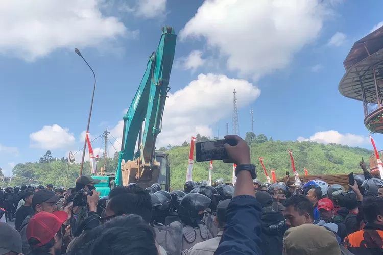 Ratusan pedagang kaki lima Puncak Bogor yang lapaknya dibongkar mengadang alat berat meminta Restoran Liwer Asep Stroberi ikut dibongkar. (Rifal)