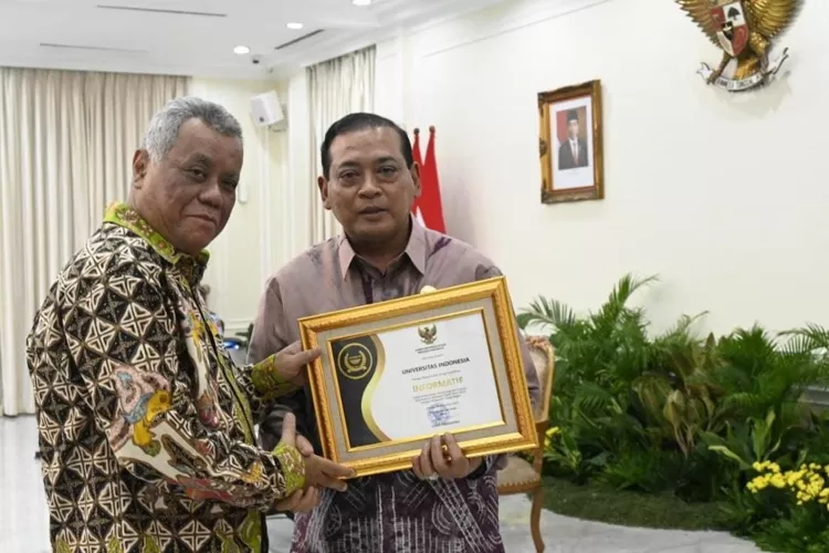 Ketua Komisi Informasi Pusat (KIP) Donny Yusgiantoro menyerahkan penghargaan kepada Rektor UI Ari Kuncoro di Istana Wakil Presiden, Jakarta, pada Selasa, (19/12). (HUMAS UI)